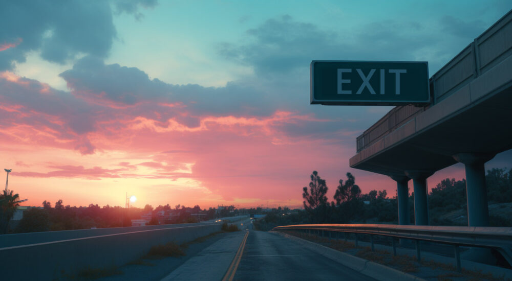 An exit sign by a highway road.