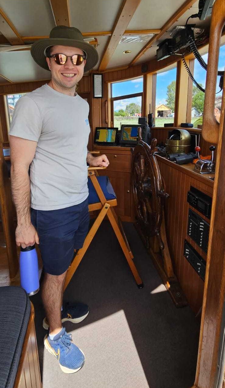 Jeremy on a boat that appears to be on land.