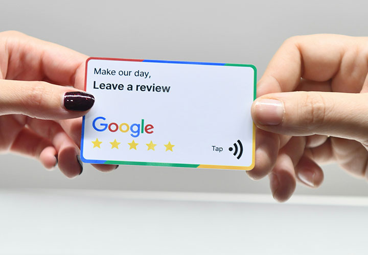 Person Holding a Google Review Card that says “Make Our Day - Leave a Review” for a Google Business Profile to Generate Reviews