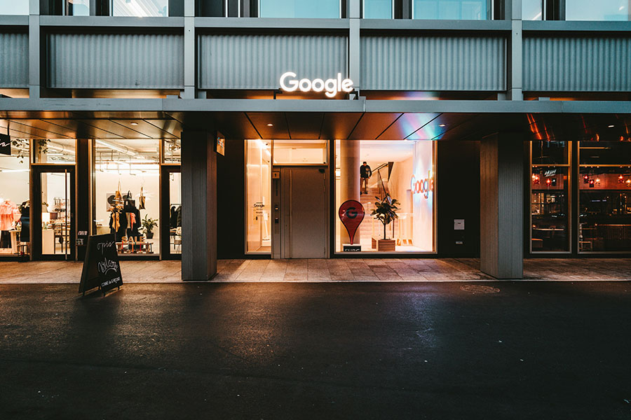 Google Office Building at Night with a Google Sign Lit Up on the Outside and Inside