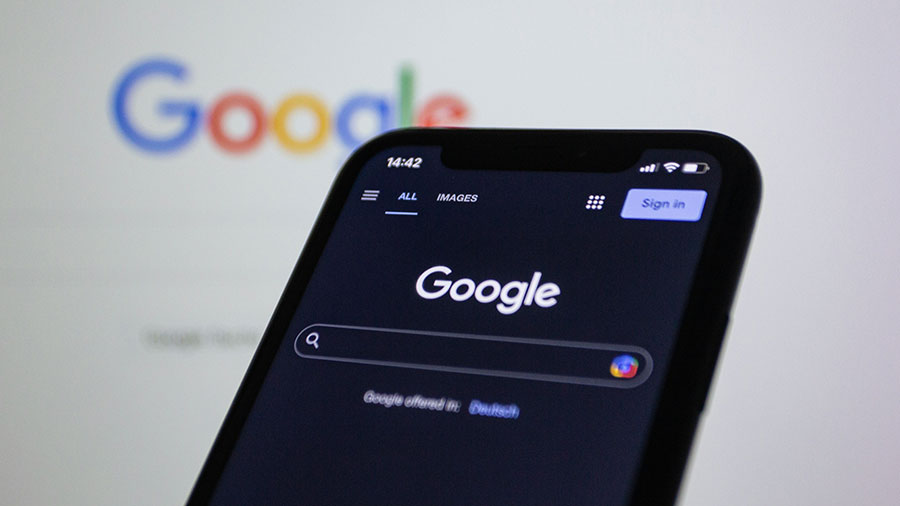 Smartphone displaying Google search screen with dark mode interface