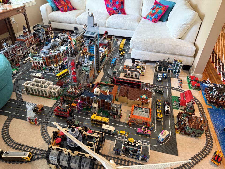 An elaborate Lego city and train track display in Flavio's living room