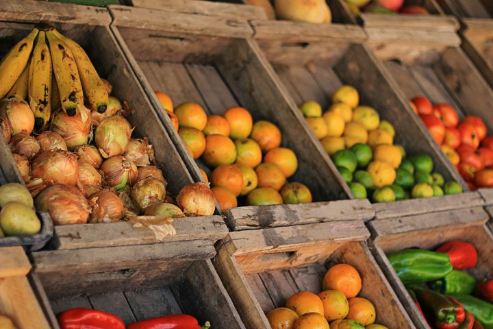 various fruits and vegetables on display in wooden crates