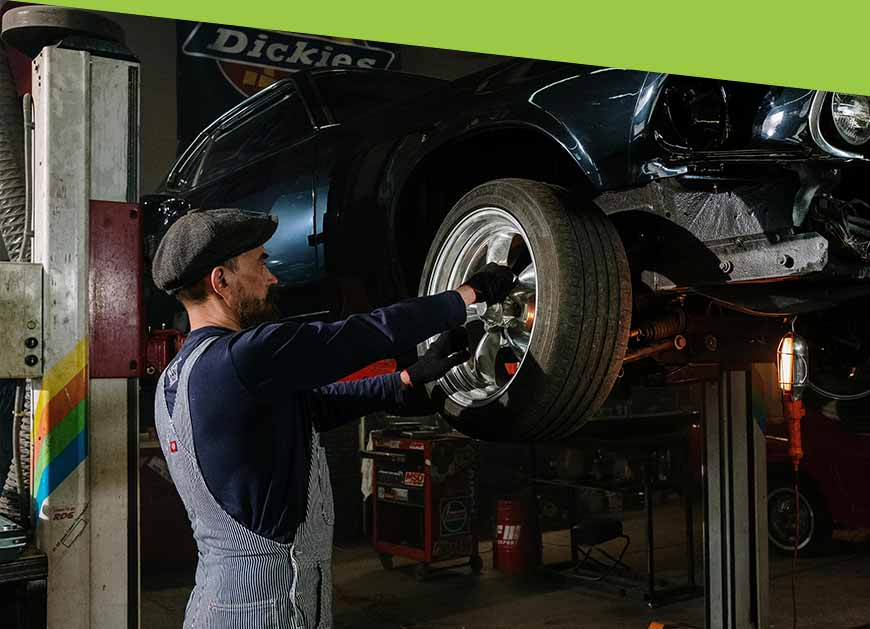 Auto repair specialist fixing a tire