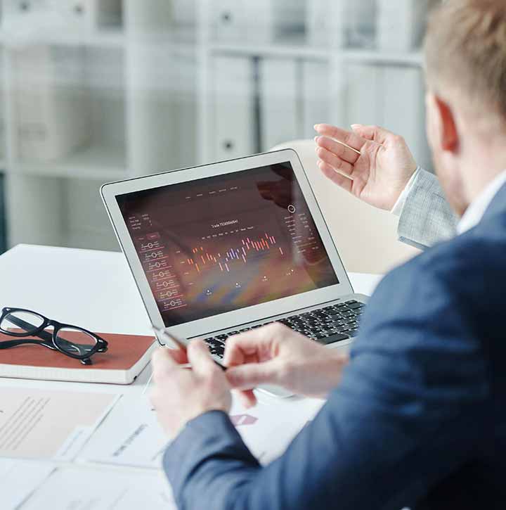 Man using a laptop in an office environment reading nuclear energy statistics