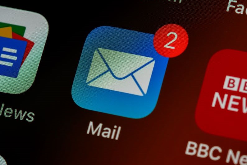the mail icon on an iPhone screen, zoomed in.