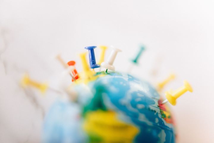 Globe Illustration of a 3D globe surrounded by colourful push pins